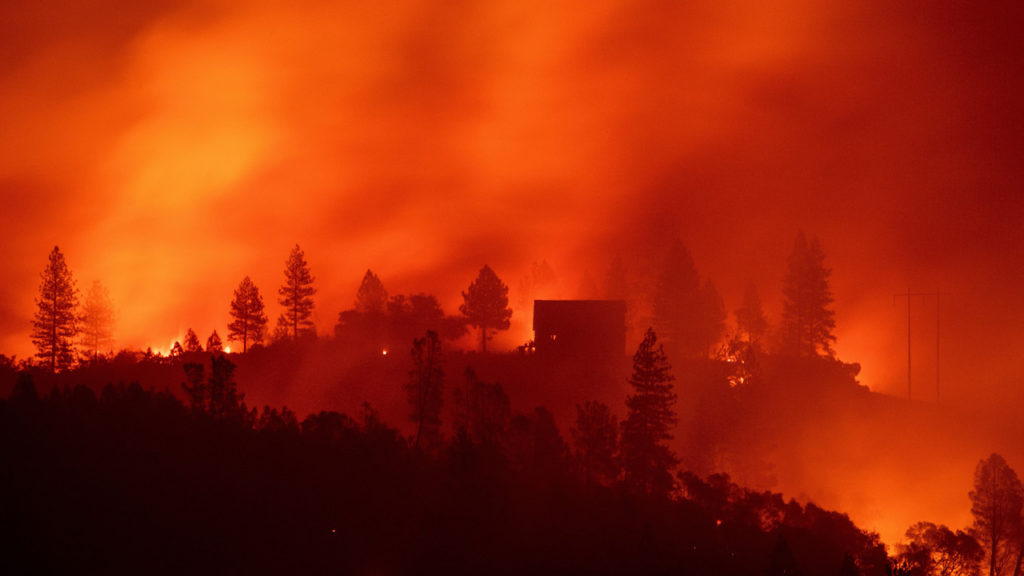 TOPSHOT - Flames from the Camp fire burn near a home atop a ridge near Big Bend, California, on November 10, 2018. - The death toll from the most destructive fire to hit California rose to 23 on November 10 as rescue workers recovered more bodies of people killed by the devastating blaze. Ten of the bodies were found in the town of Paradise while four were discovered in the Concow area, both in Butte County. (Photo by Josh Edelson / AFP) (Photo credit should read JOSH EDELSON/AFP/Getty Images)